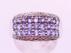 A 9 ct white gold, tanzanite and diamond ring. Ring size P/Q. 4.1 grammes total weight.