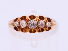 An 18 ct gold five-stone diamond ring. Ring size M.