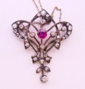 A Victorian diamond and ruby pendant necklace. Pendant 3.5 cm high, chain 40 cm long.