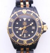 A boxed ladies' Tag Heuer 1000 980.029N black dial wristwatch. 3 cm wide.