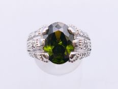 A 10 KT white gold dress ring, possibly set with a tourmaline. Ring size T/U.
