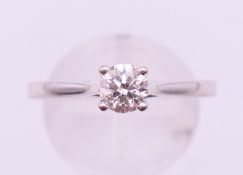 An 18 ct white gold diamond solitaire ring. The claw set stone approximately 0.5 carat. Ring size R.