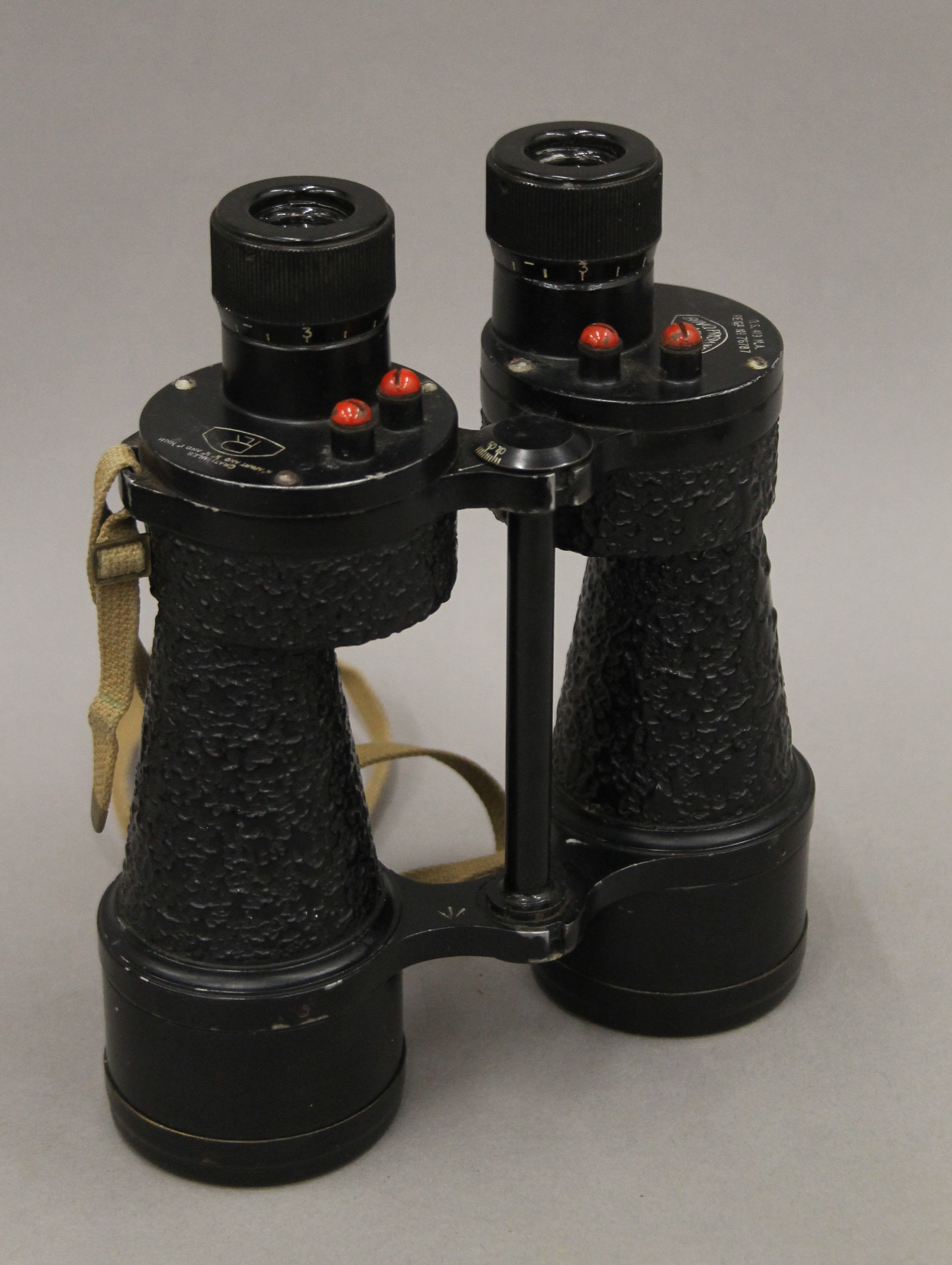A cased pair of military binoculars. 22 cm high.