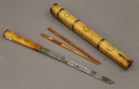 A Chinese bone, brass and copper eating set, the knife with steel blade, and two chopsticks,