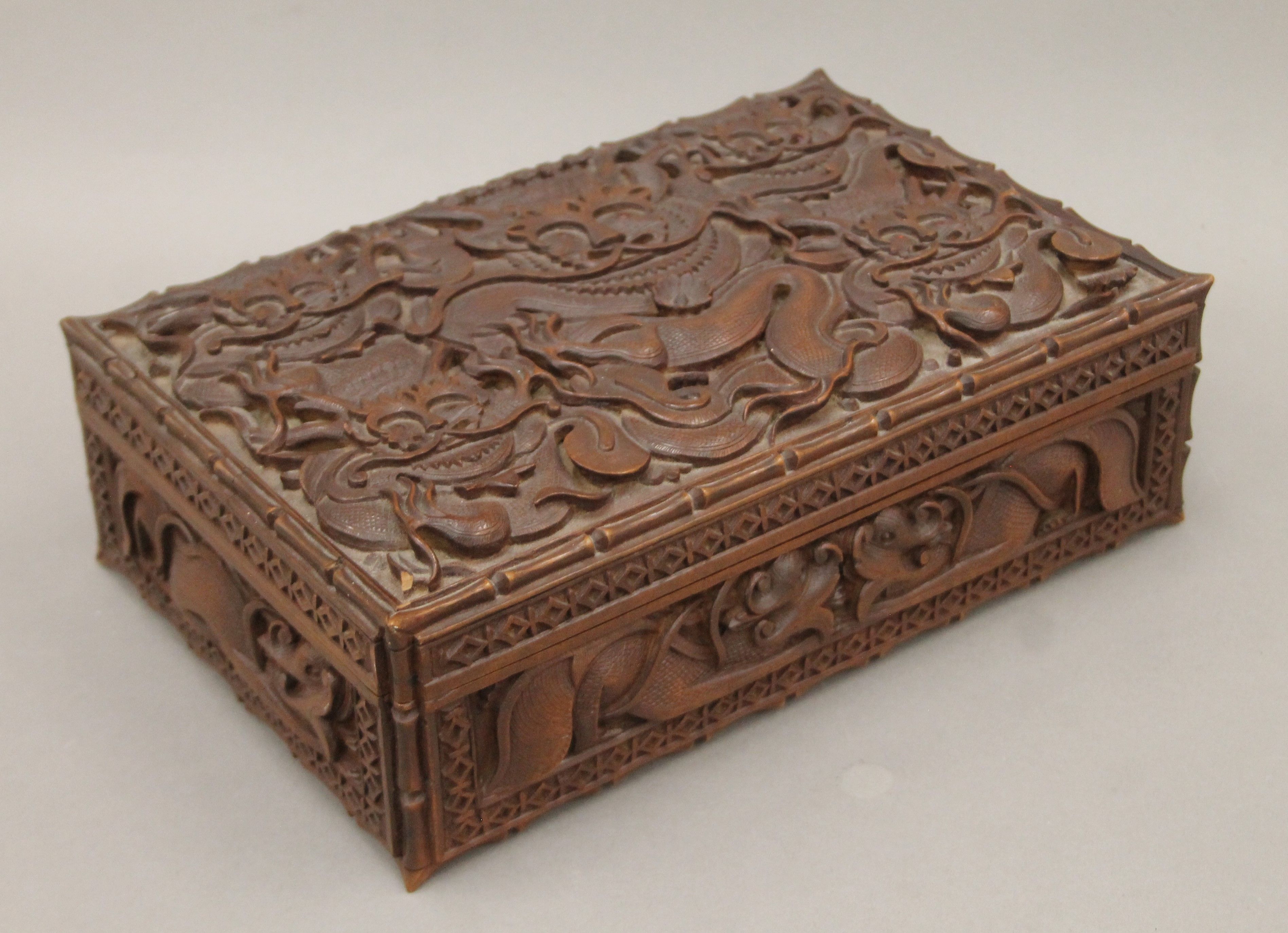 An Eastern carved hardwood box with all-over carved dragon decoration. 30 cm wide. - Image 2 of 6