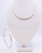 An 18 ct white gold and diamond necklace (43 cm long), the central stone approximately 0.