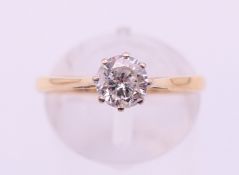 An 18 ct gold diamond solitaire ring. The claw set stone approximately 0.5 carat. Ring size N/O.