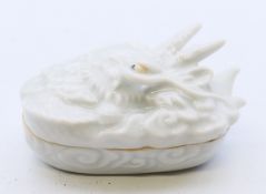 A Chinese blanc de chine box, the lid formed as a dragon. 6.5 cm long.