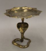 An Indian metal compote dish with snake-form support. 18.5 cm high.