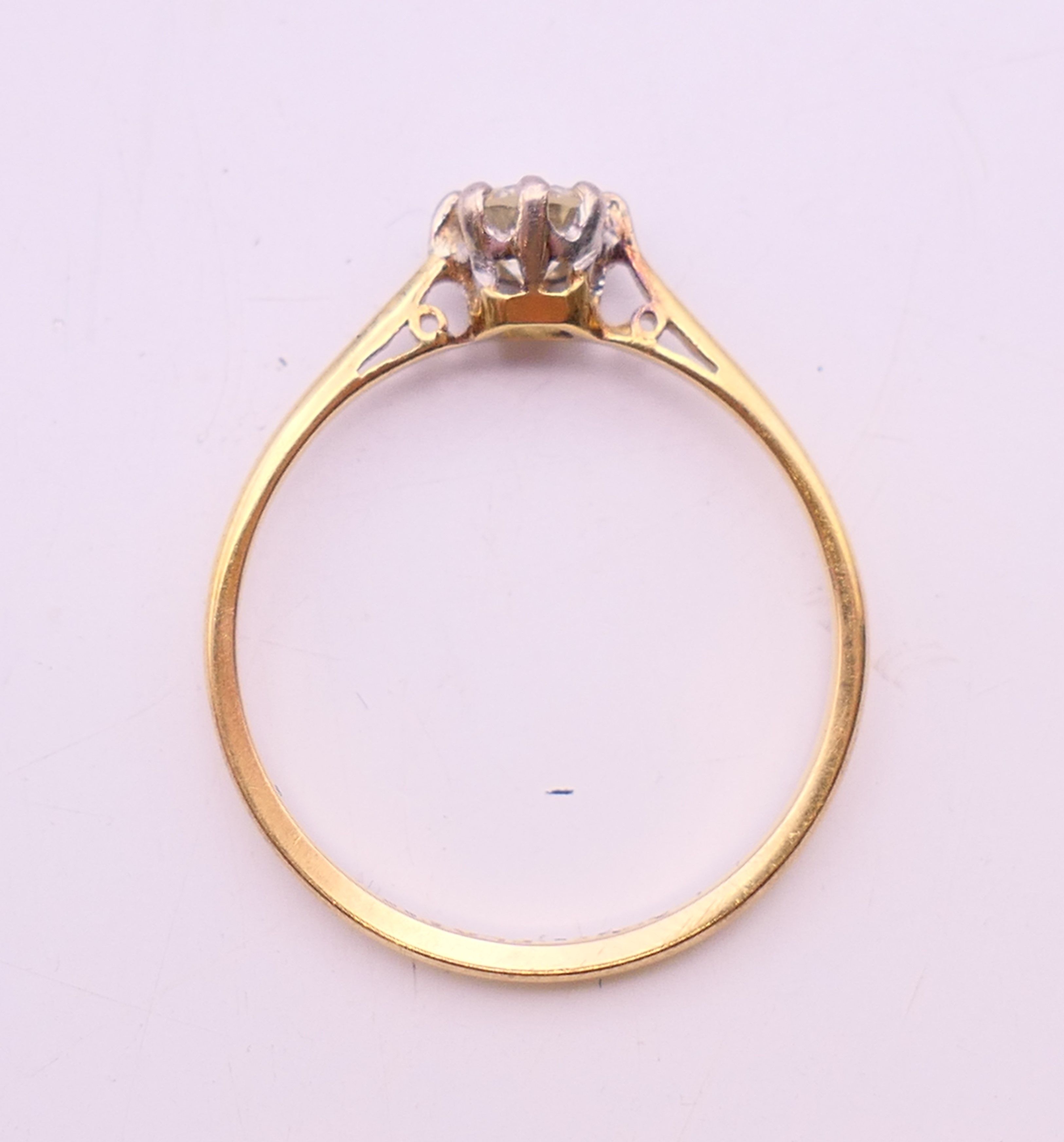 An 18 ct gold and platinum diamond solitaire ring. The claw set stone spreading to 0.25 carat. - Image 6 of 7
