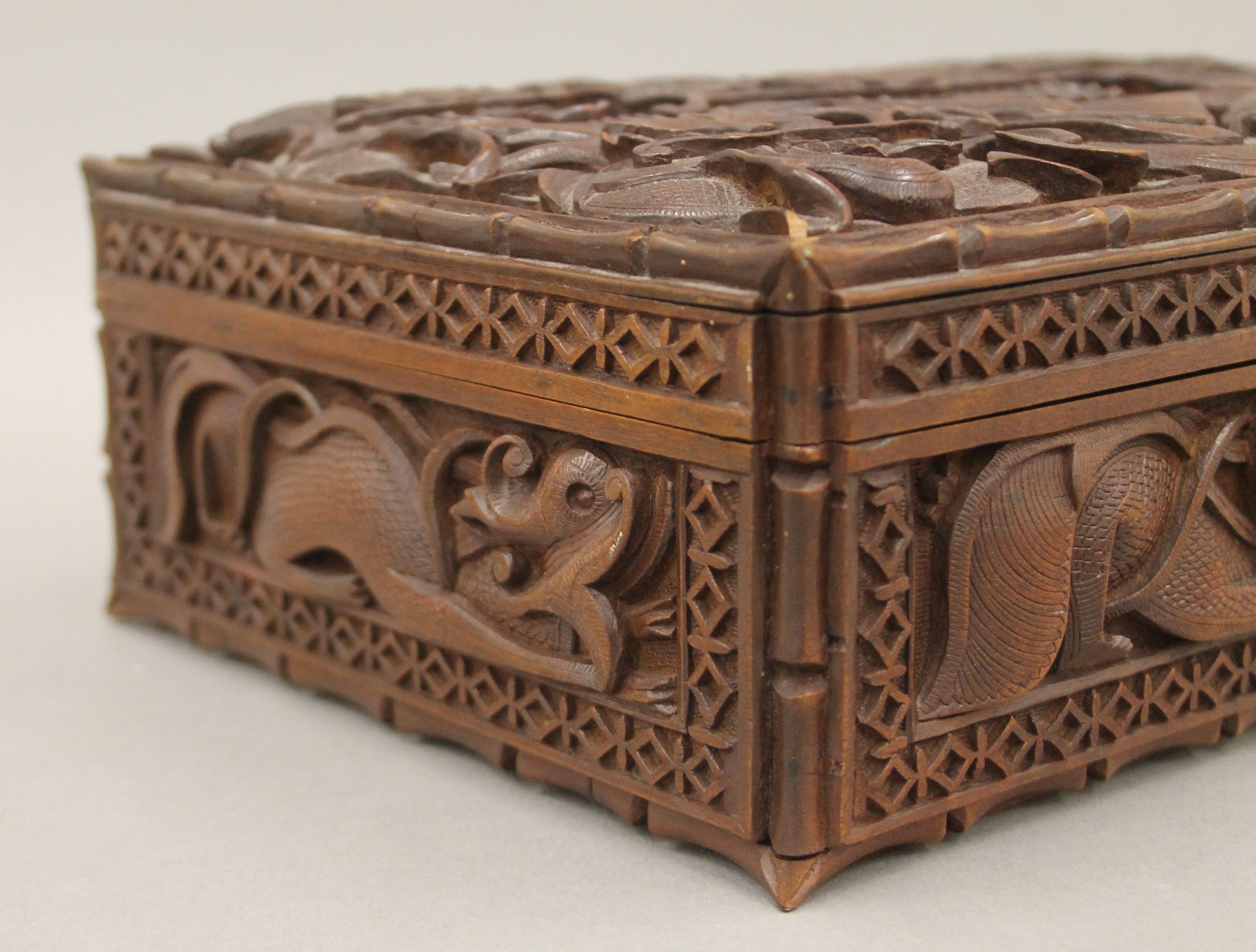 An Eastern carved hardwood box with all-over carved dragon decoration. 30 cm wide. - Image 6 of 6