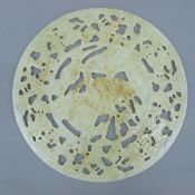 A Chinese hardstone disc with pierced decoration of cranes amongst clouds. 26 cm diameter.