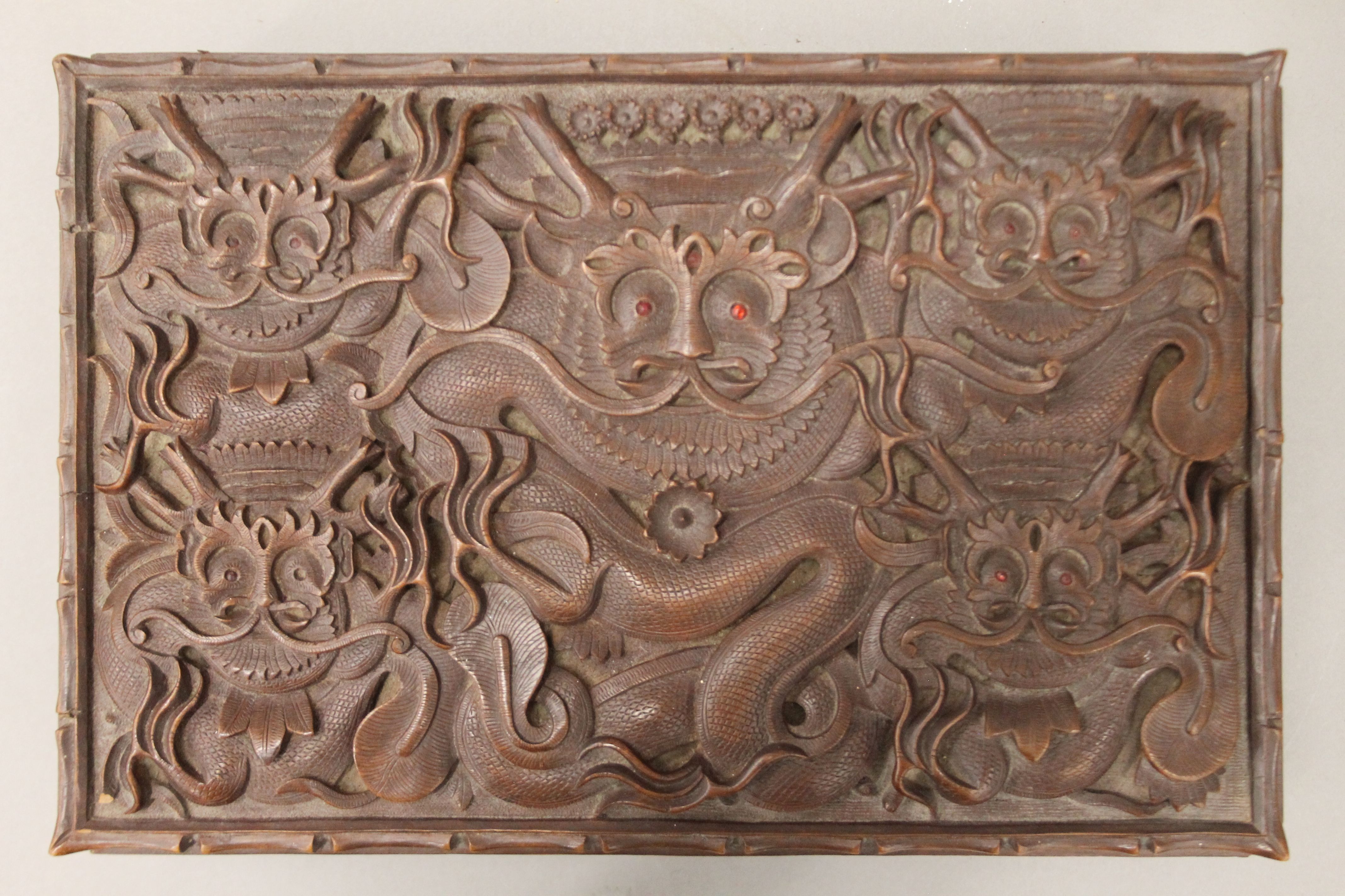 An Eastern carved hardwood box with all-over carved dragon decoration. 30 cm wide. - Image 3 of 6