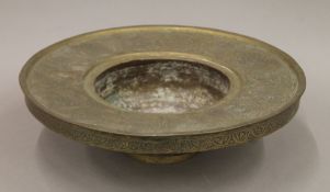A decorated Islamic brass bowl. 34 cm diameter.