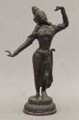 An antique Indian bronze model of a deity. 24 cm high.