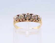 An unmarked 18 ct gold five-stone diamond ring. Ring size M/N.