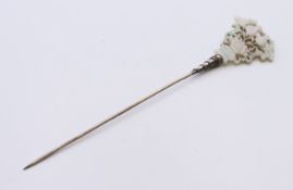 A Chinese carved jade hat/hair pin. 17 cm high.