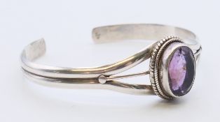 A silver and amethyst bracelet. 6 cm inner diameter.