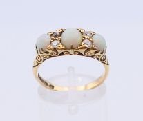 An 18 ct gold diamond and opal ring. Ring size Q/R.