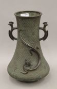 A 19th century Japanese bronze vase decorated with dragons. 30 cm high.
