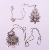 Two pendants on silver chains. The largest 6 cm high.