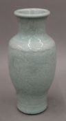 An 18th century Chinese porcelain celadon vase with carved background and crackleware glaze.