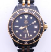 A boxed gentlemen's Tag Heuer 1000 980-029B black dial wristwatch. 4 cm wide.