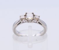 A platinum three-stone diamond ring,