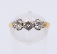 A three-stone diamond ring. Ring size N.