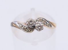 A 9 K gold diamond crossover ring. Ring size L.