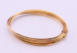 An 18 ct gold bangle, 6 cm inner diameter. 12.2 grammes.