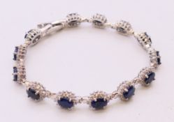 A silver dress bracelet, possibly sapphire and diamond. 18 cm long.