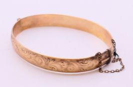 A gold plated bangle. 6.5 cm inner diameter.