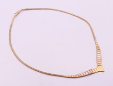 A three tone 9 ct gold necklace 42 cm long 10.1 grammes.