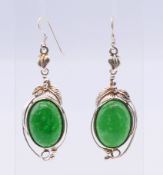 A pair of silver and jade earrings. Each 4 cm high.