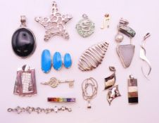 A quantity of silver pendants, the largest 4.5 cm. 110.7 grammes total weight.