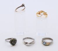 A 9ct gold ring and four dress rings. The former ring size K/L.