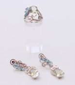 A silver dress ring and a pair of matching earrings. Ring size N/O.