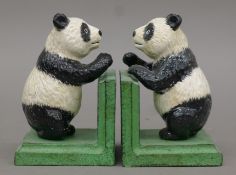A pair of cast iron panda bookends. 13 cm high.
