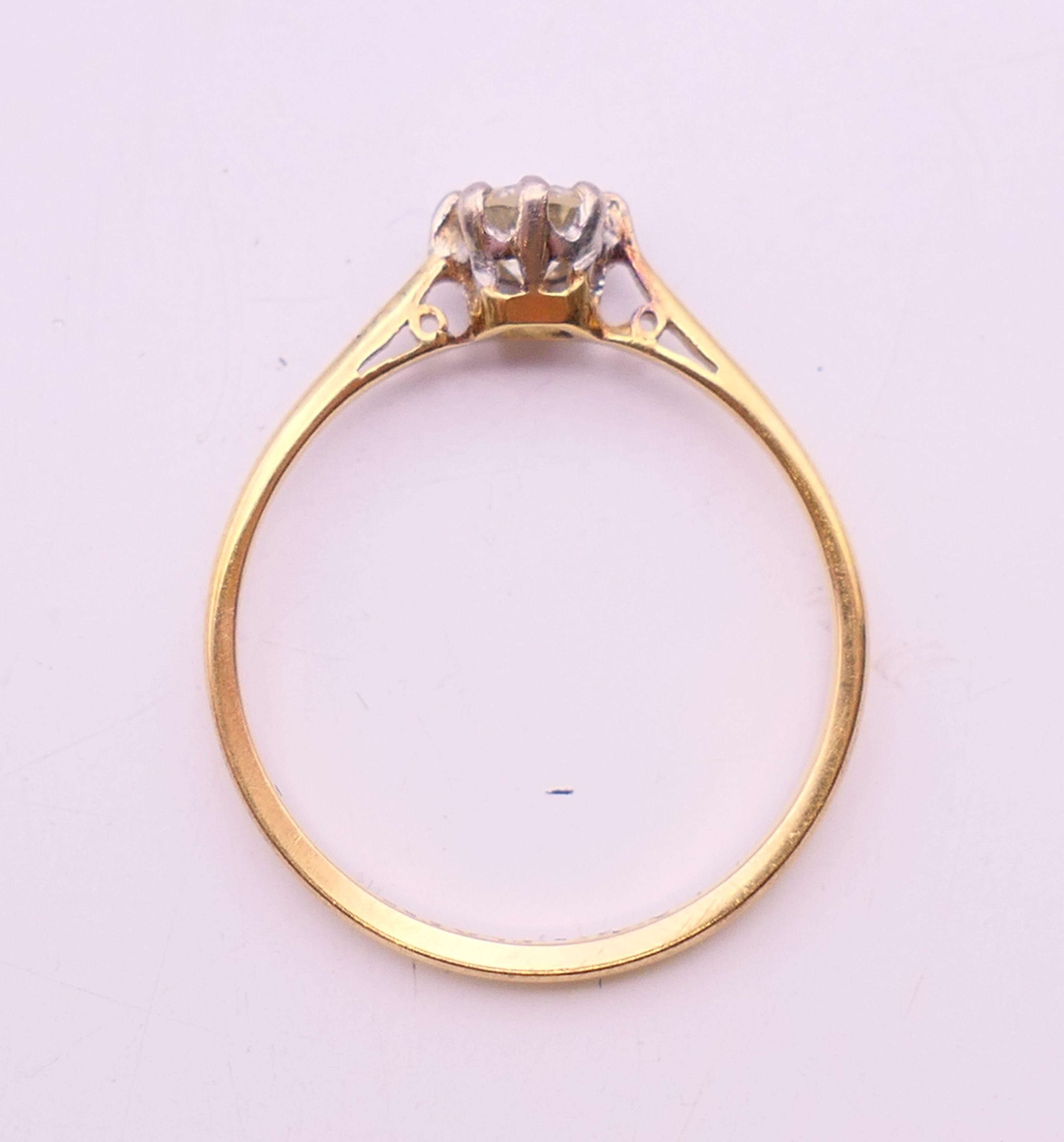 An 18 ct gold and platinum diamond solitaire ring. The claw set stone spreading to 0.25 carat. - Image 6 of 7
