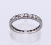 A platinum and diamond eternity ring. Ring size K/L.