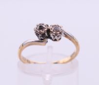 A 9 ct gold and platinum diamond cross over ring. Ring size L/M.