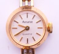A 9 ct gold Accurist ladies wristwatch. 1.5 cm wide. 12.3 grammes total weight.