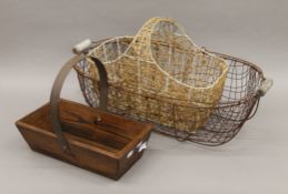Two wirework baskets and a wooden trug. The largest 65 cm long.