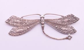 A silver dragonfly brooch. 10 cm wide.