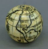 A bone globe compass. 7 cm diameter.