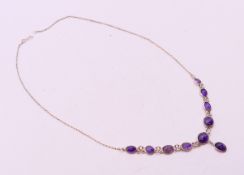 A silver and amethyst-set necklace. 39 cm long.