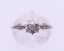 A platinum and diamond ring. The central stone spreading to approximately 0.75 carat. Ring size M.