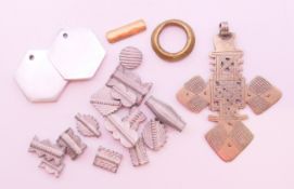 A Coptic cross and various metal beads, etc. The former 11 cm high.