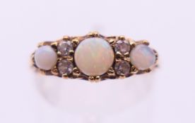 A 9 ct gold, diamond and opal ring. Ring size P/Q.